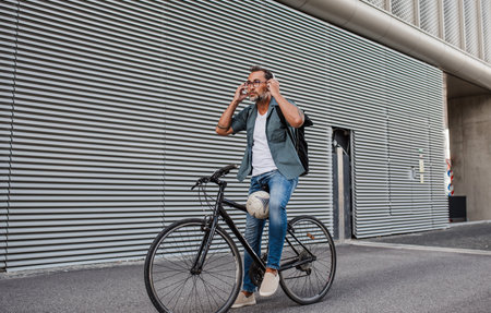 City commuter putting headphones on head before ride.の写真素材