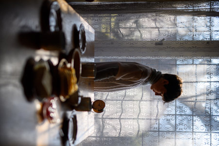Young girl standing in old kitchen.