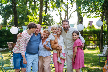 Grandparents, parents and children posing together at family celebrationの写真素材