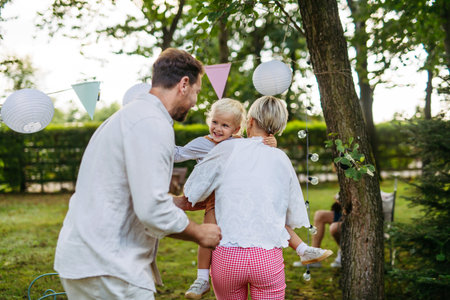 Potrait of young family during grill garden party.の写真素材