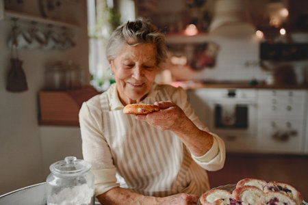 Grandmother preparing homemade sourdough cakes.の写真素材