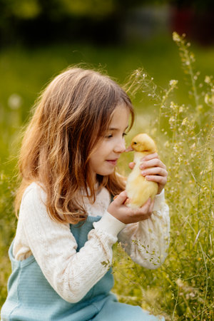 Lovely girl cuddling baby duckling.の写真素材