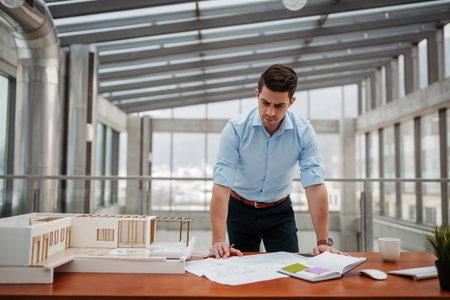Young businessman, engineer working in office, working on plan or technical document.の写真素材