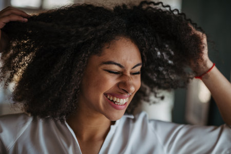 Close-up portrait of beautiful young woman with curly hair.の写真素材