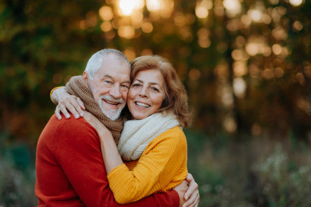 Portrait of senior couple in autumn nature.の写真素材
