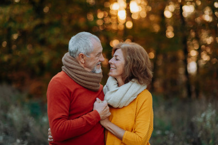 Portrait of senior couple in autumn nature.の写真素材