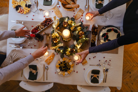 Top view of family preparing table for Christmas dinner.の写真素材