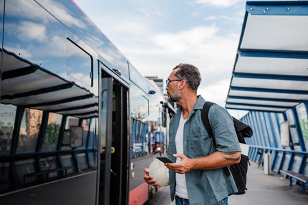 Mature man entering bus. Concept of public transportation.の写真素材
