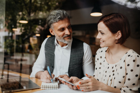 Man and woman having business meeting in a coffee shop.の写真素材