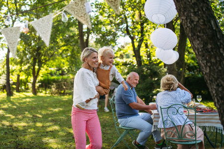 Whole family during grill garden party outdoors.の写真素材