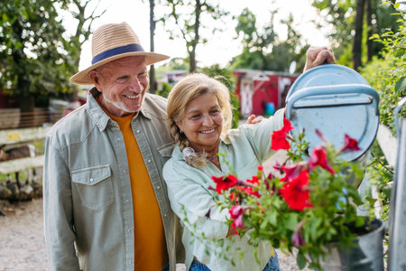 Happy elderly couple enjoying gardening in countryside.の写真素材