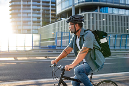 Male cyclist riding bike down the street.の写真素材