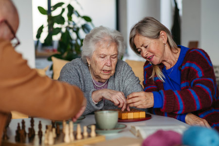 Group of senior people enjoying different activities in community center.の写真素材