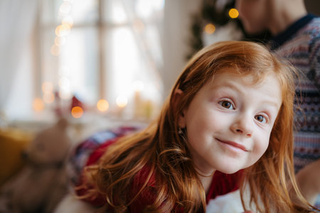 Portrait of small girl indoors at home at Christmas, wearing pyjamas.の写真素材