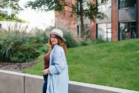 Plus size woman standing outdoors in the city.の写真素材