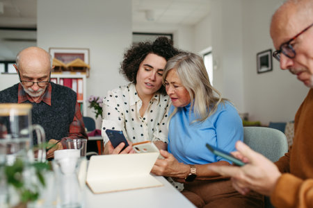 Tutor teaching seniors about phone scams and digital safety.の写真素材