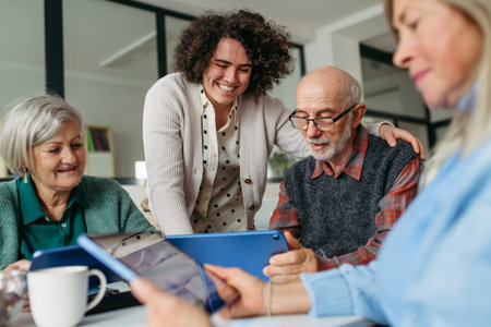 Tutor teaching seniors about phone scams and digital safety.の写真素材