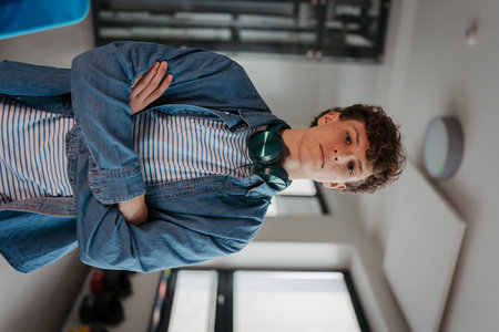 Confident teen student with headphones in school.の写真素材