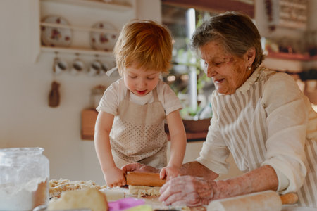 Family holiday baking with grandma in cozy kitchen.の写真素材