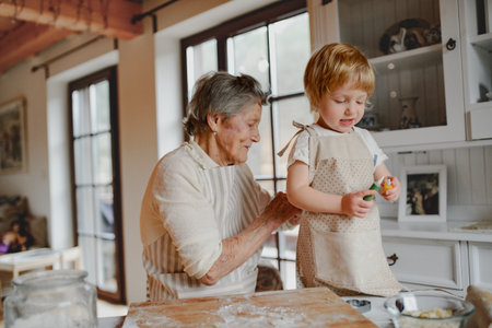 Family holiday baking with grandma in cozy kitchen.の写真素材