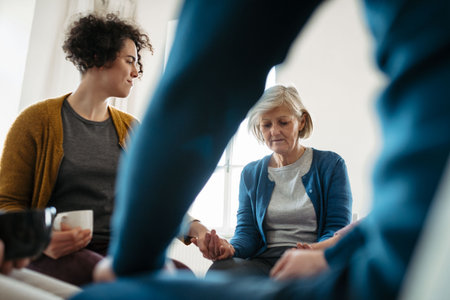 Group of people sitting in a circle and sharing experiences during guided therapeutic session.の写真素材