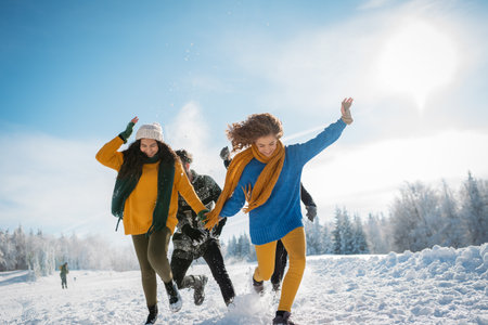 Group of friends enjoying winter time in snowy nature.の写真素材