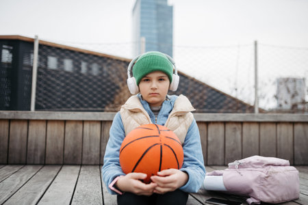 Sad girl alone in the city, want to play basketball. Young girl spending free time alone in the...