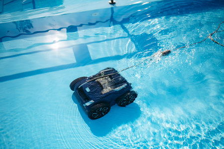 Robotic pool cleaner working underwater to keep swimming pool clean.の写真素材