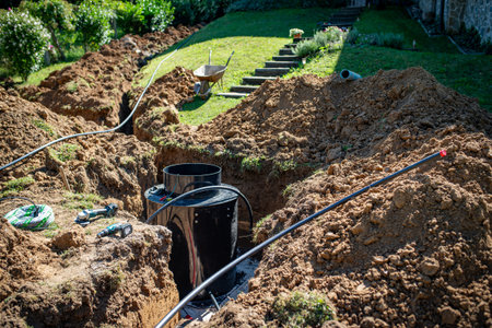 Installing underground utility shaft during construction work.の写真素材