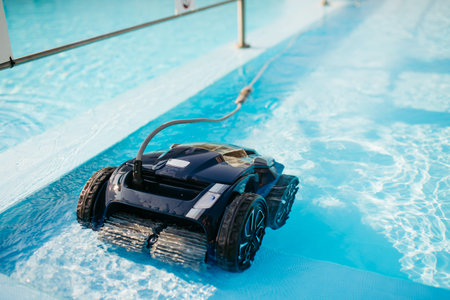 Robotic pool cleaner working underwater to keep swimming pool clean.の写真素材