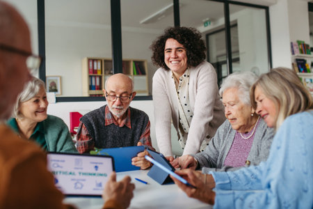 Tutor teaching seniors about phone scams and digital safety.の写真素材