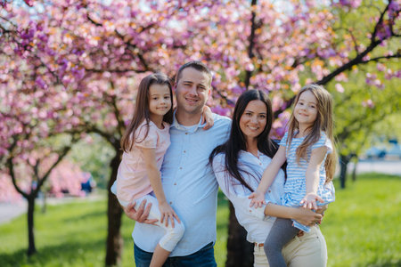 Young family standing outside in spring nature.の写真素材