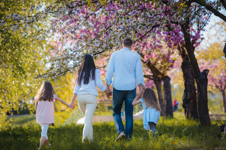 Rear view of family on walk in spring nature.の写真素材