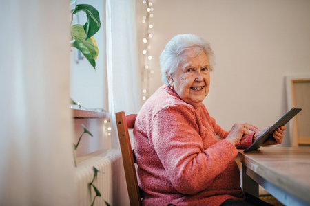 Older woman using tablet, shopping online.の写真素材