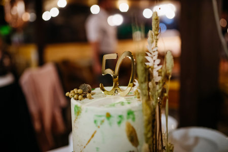 Modern birthday cake with natural decoration at birthday party.の写真素材