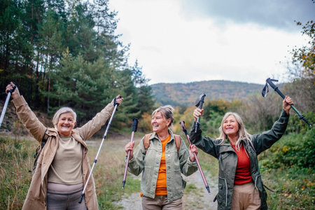 Group of mature female friends enjoying countryside walk.