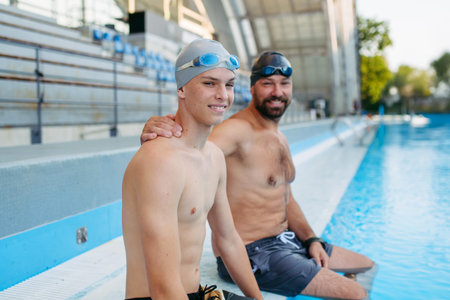 Father and teenage son enjoying swim training together.