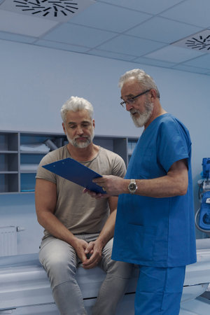 Doctor explaining CT scan results to patient in hospital setting
