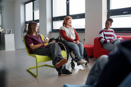 Teen students talking together in inclusive school setting.