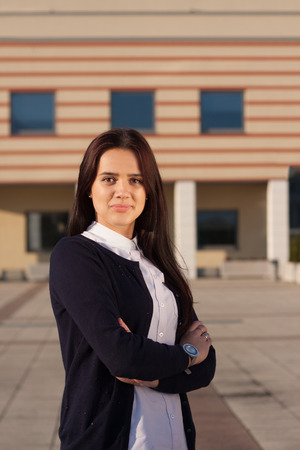 Young beautiful ambitious business woman in front of workplaceの写真素材