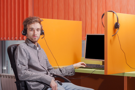 Portrait of handsome young call center agent at workの写真素材