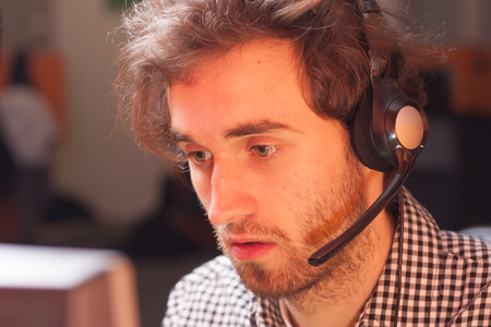Handsome young call center agent at workの写真素材
