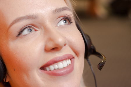 Detail of beautiful young call center agent at workの写真素材