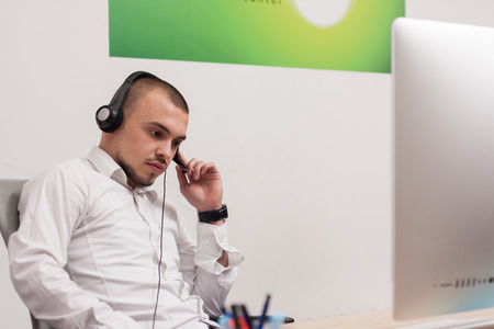 Handsome young call center agent at workの写真素材