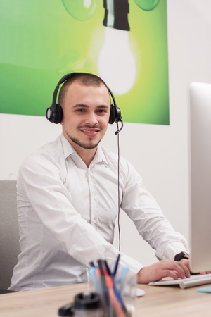 Handsome young call center agent at workの写真素材