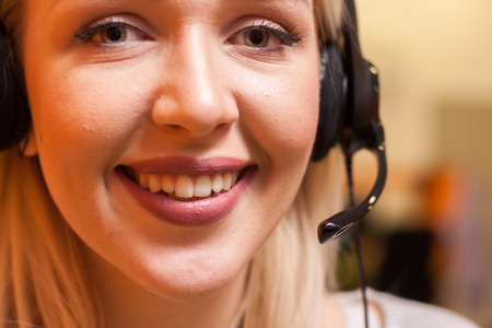 Detail of beautiful young call center agent at workの写真素材