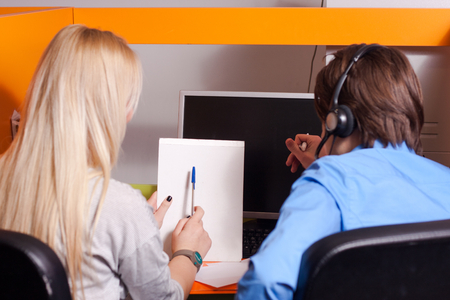 Portrait of call center agent at work in box officeの写真素材