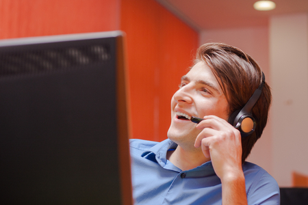 Portrait of call center agent at work in box officeの写真素材