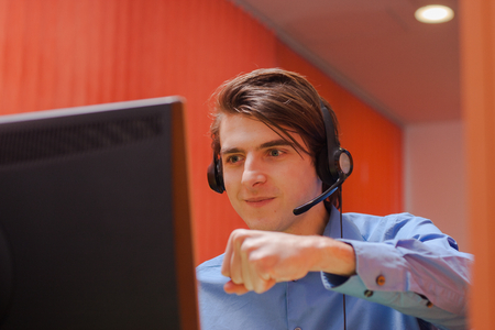 Portrait of call center agent at work in box officeの写真素材