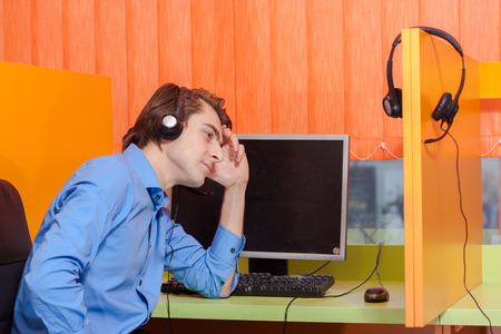 Portrait of call center agent at work in box officeの写真素材